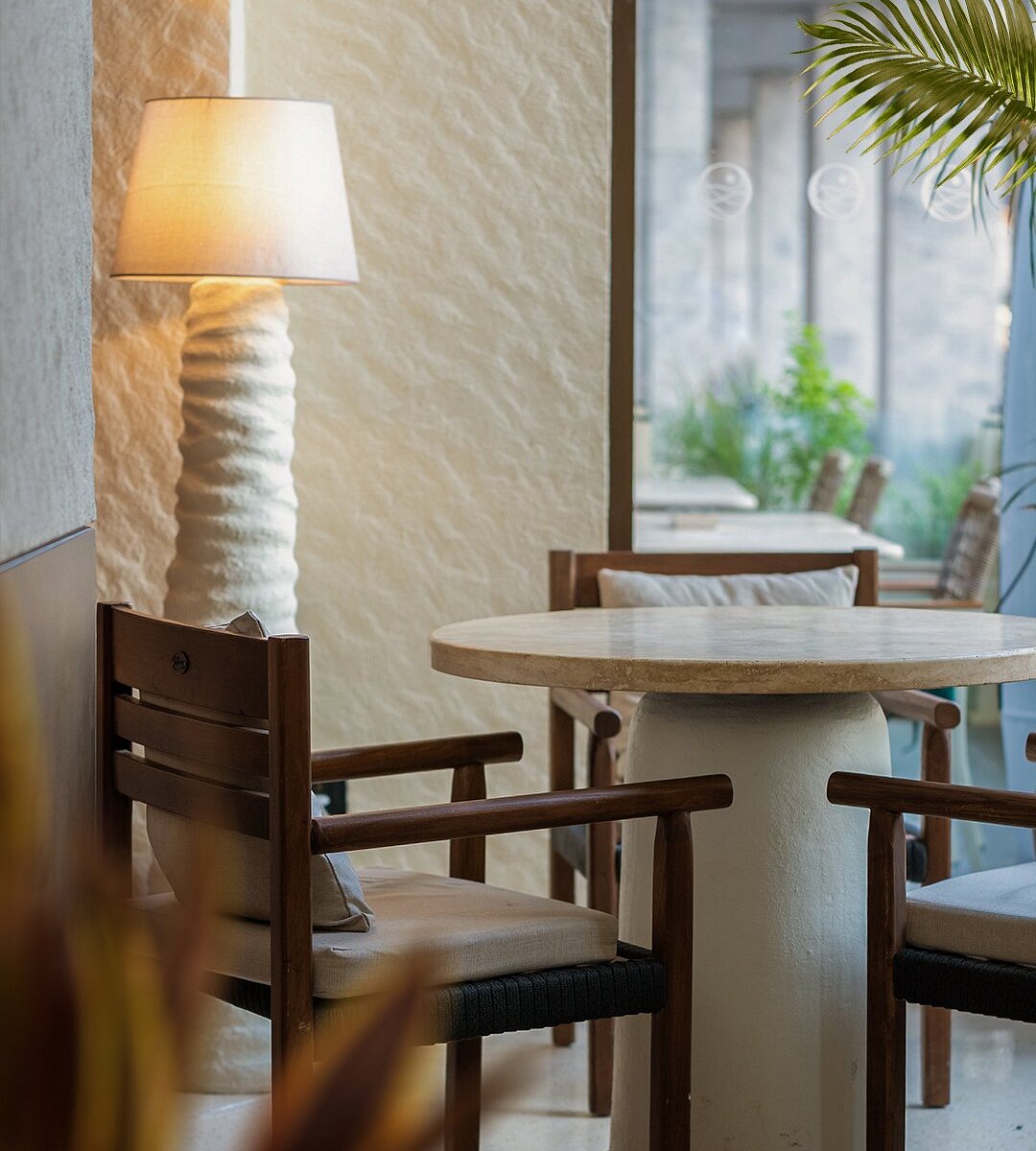 FRODA interior with warm wood tables and soft pendant lighting